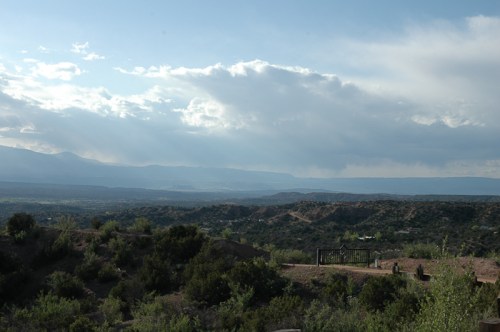Expansiveness is the feeling as one looks at the valley from a gate at the top of the mountain in Tesuque, New Mexico.